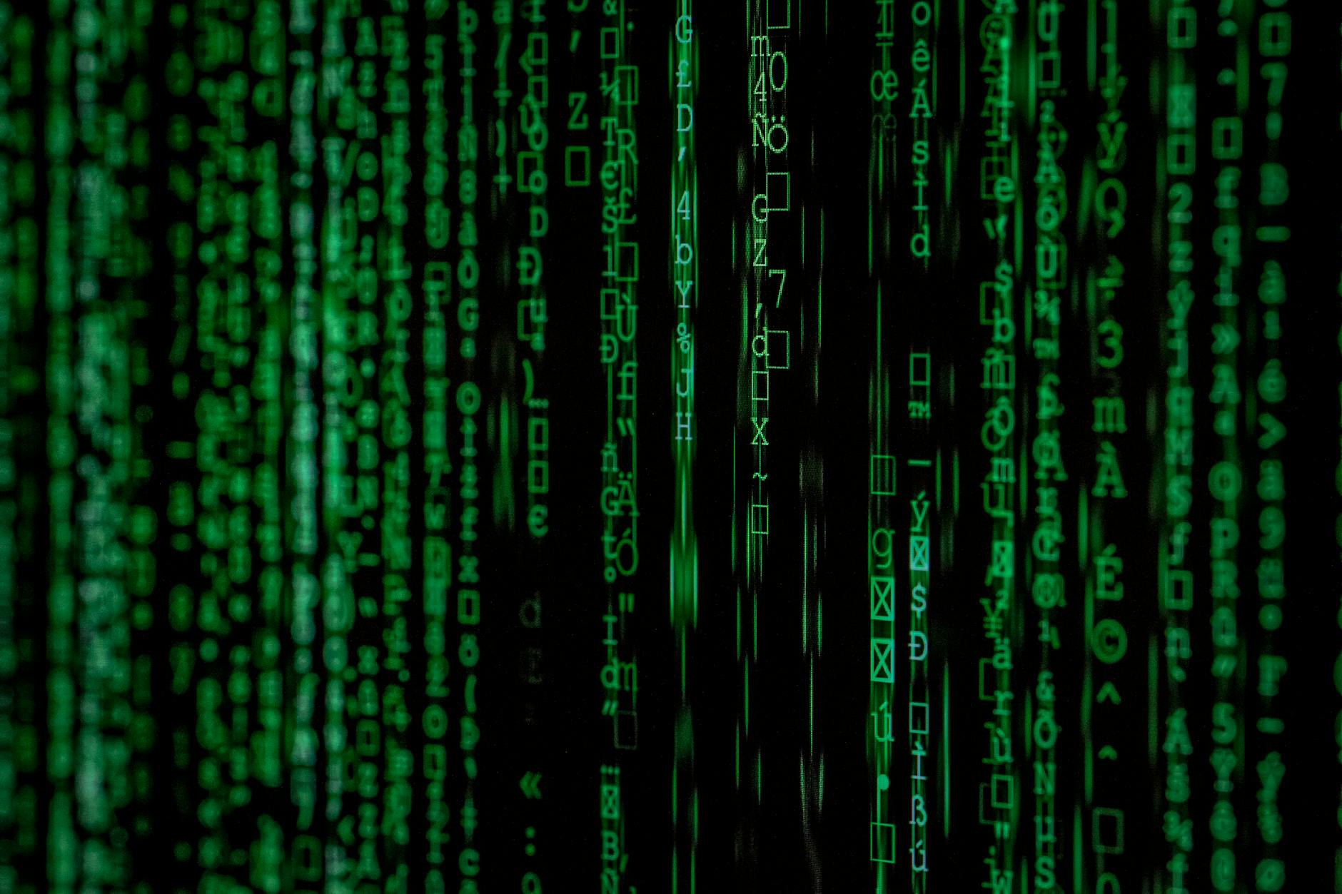 Zielone cyfry binarne na abstrakcyjnym, ciemnym tle matrix